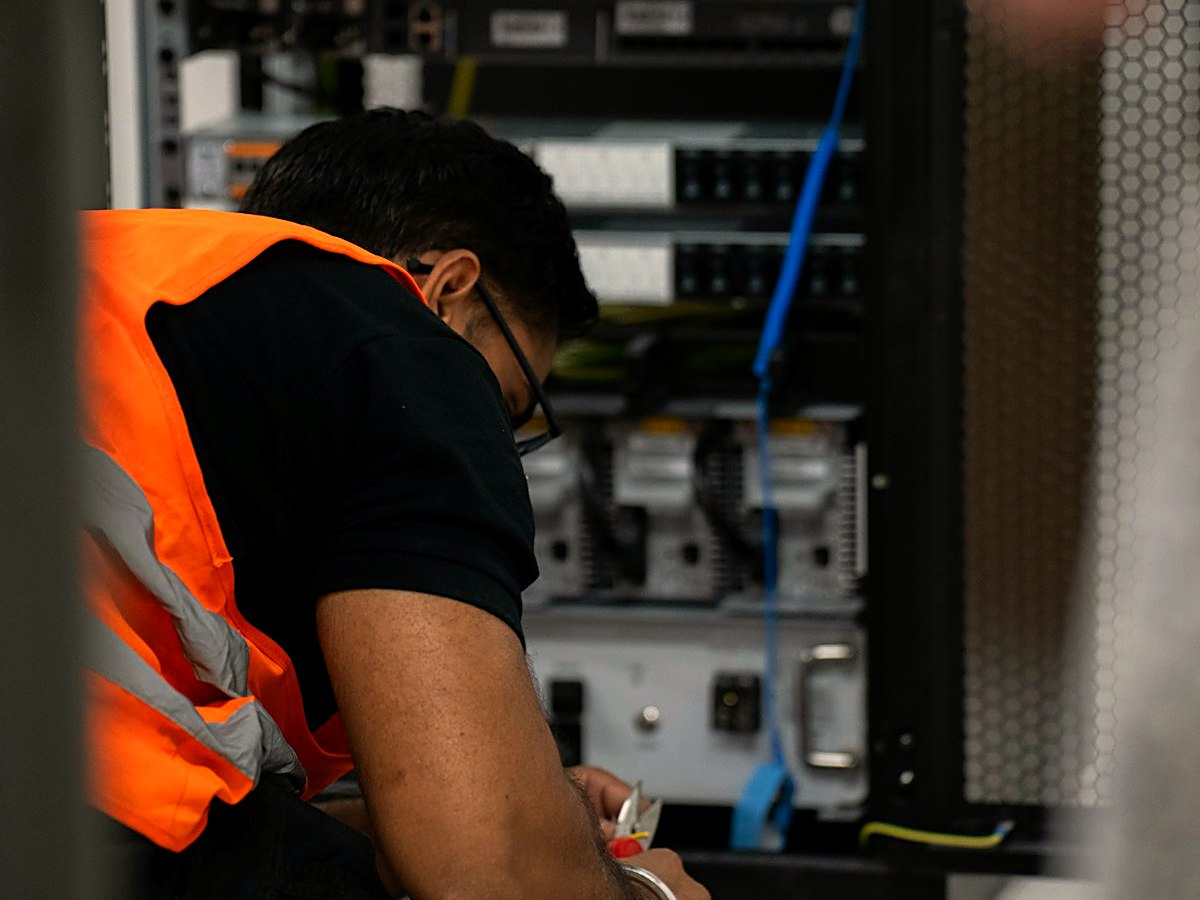 Technician installing and wiring custom control and integration hardware